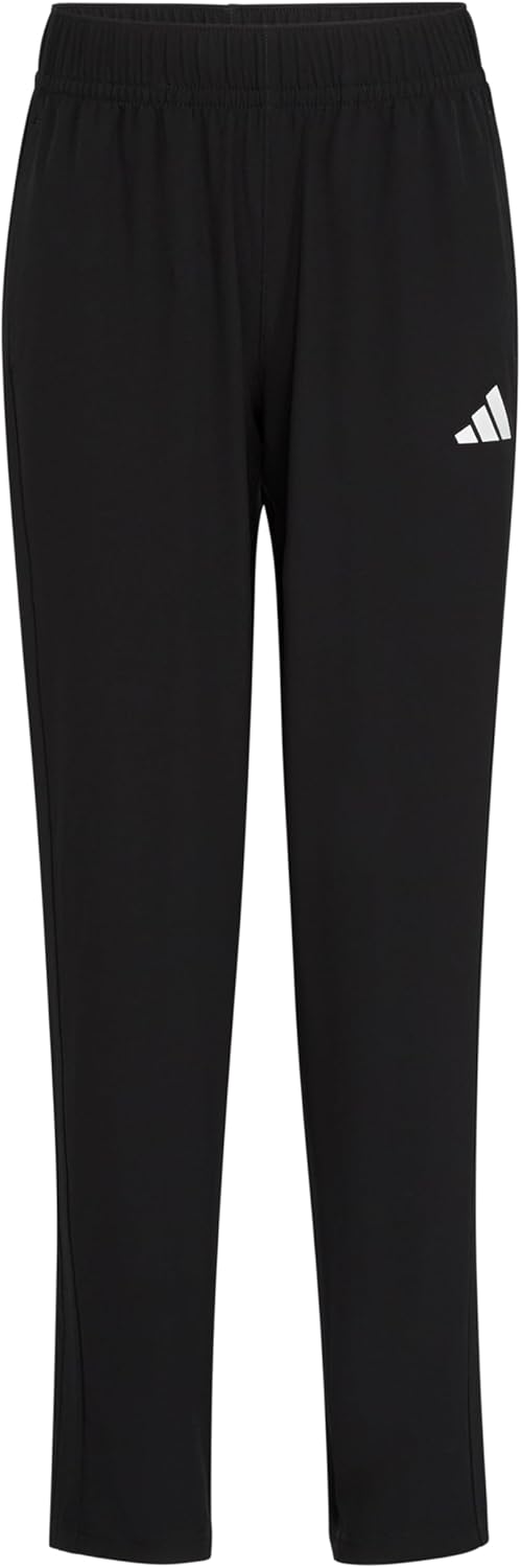 Child wearing adidas Boys Track Pants Large Black AK10022 on a playground